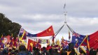 Protesters and pro-China supporters on the front lawn of Parliament House ahead of a visit from Chinese Premier Li Qiang on Monday.