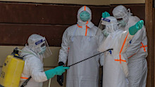 Health workers disinfect themselves after preparing the body of an Ebola victim at Citadelle Clinic in Bunia, Congo, Friday, June 12, 2026. 