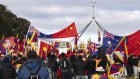 Protesters and pro-China supporters on the front lawn of Parliament House ahead of a visit from Chinese Premier Li Qiang on Monday.