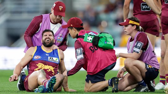 Marcus Adams pictured being assisted by trainers during round 21 last season.