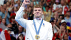 Leon Marchand of Team France celebrates on the podium during the Swimming medal ceremony after the Men’s 400m Individual Medley Final on day two. 