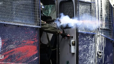 Riot police fire tear gas at protesters during clashes in Karava, Lesbos, near the area where the government plans to build a new detention centre.