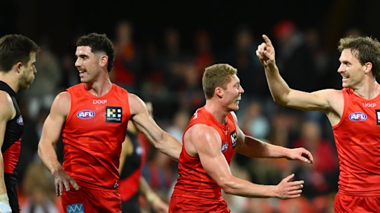 Noah Anderson of the Suns celebrates kicking a goal.