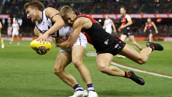 Bombers skipper Dyson Heppell lays a desperate tackle on Fremantle’s Mitch Crowden.