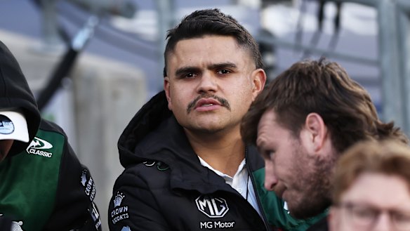 Latrell Mitchell watches on.