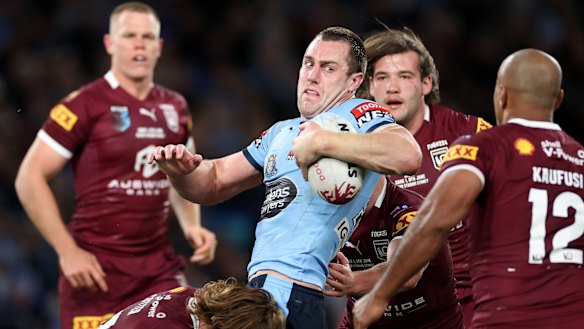 Isaah Yeo is tackled by the Queensland defence.