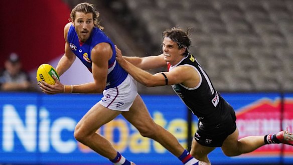 Dog gone: Saints' Hunter Clark gets to grips with Western Bulldogs captain Marcus Bontempelli.