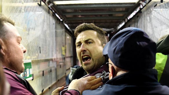 Security and police swooped on a Manly fan, centre, who confronted Melbourne Storm’s Will Chambers on Saturday night at Lottoland.