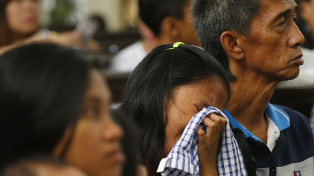 A relative cries as she pays homage to alleged victims of President Rodrigo Duterte's so-called war on drugs at a religious service ahead of the observance of All Souls Day on October 30, 2018, in Manila. 