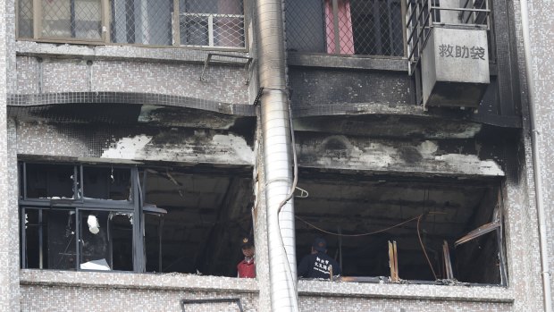  Fire inspectors view damages after a fire broke out at the Taipei Hospital in Hsinchuang, New Taipei City, Taiwan, on Monday.