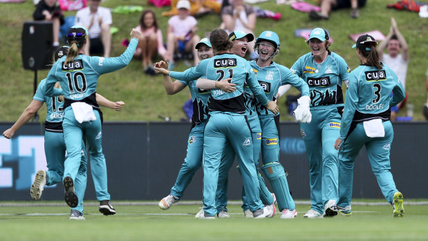 Grandstand finish: The Heat celebrate after beating the Thunder in the Women's Big Bash League semi-final.