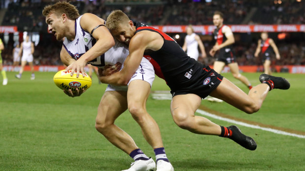 Bombers skipper Dyson Heppell lays a desperate tackle on Fremantle’s Mitch Crowden.