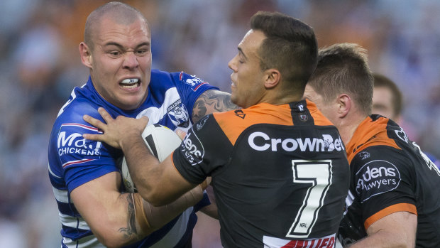 Rampaging: David Klemmer takes the ball forward for the Dogs. 