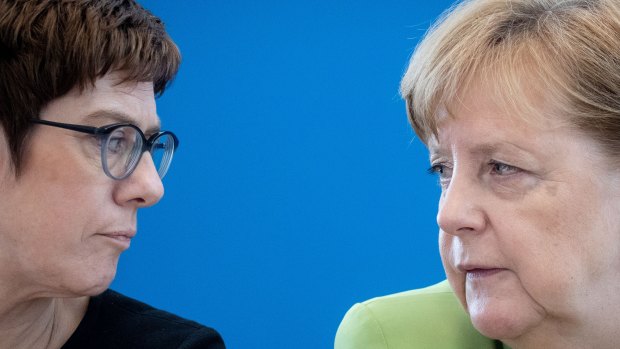 You complete me?: Angela Merkel (right) speaks to the woman known as AKK - and 'mini-Merkel' - in Berlin in May.