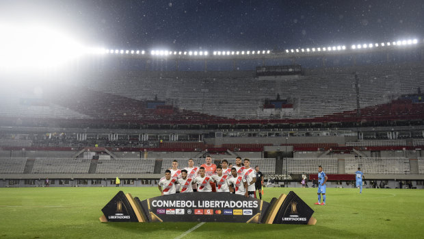 River Plate players pose for a photo at an empty Estadio Monumental Antonio Vespucio Liberti in Buenos Aires.