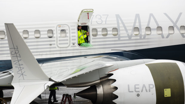 An employee works on a Boeing 737 Max 9 plane at the company's manufacturing facility in Renton, Washington.