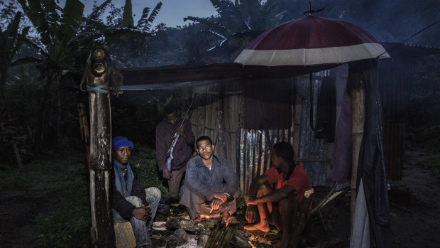 Ninot Oclin, centre, guards his small vanilla farm from thieves in Mandena, Madagascar.