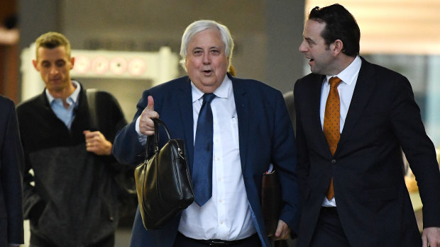 Businessman Clive Palmer (centre) leaves the District Court in Brisbane on July 23.
