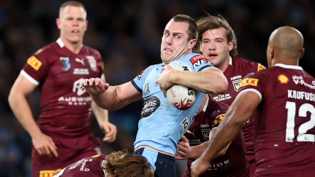 Isaah Yeo is tackled by the Queensland defence.