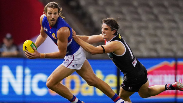 Dog gone: Saints' Hunter Clark gets to grips with Western Bulldogs captain Marcus Bontempelli.