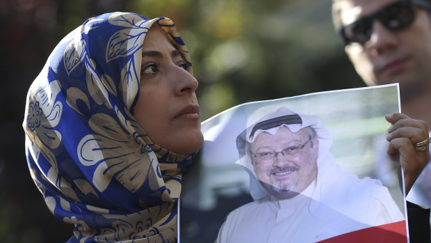 Holding a picture of missing Saudi writer Jamal Khashoggi, Tawakkol Karman, the Nobel Peace Prize laureate for 2011, talks to members of the media near the Saudi Arabia consulate in Istanbul on Friday.