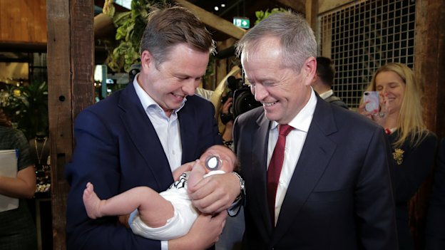 Opposition Leader Bill Shorten with his chief of staff Ryan Liddell, holding baby Ivy.