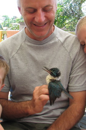 Ornithologist Peter Higgins with a sacred kingfisher.