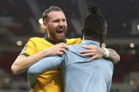 Martin Boyle and Awer Mabil celebrate the Socceroos win over UAE