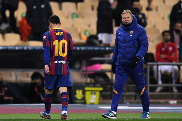 Lionel Messi heads off the pitch after being shown a red card, as his coach Ronald Koeman looks on.