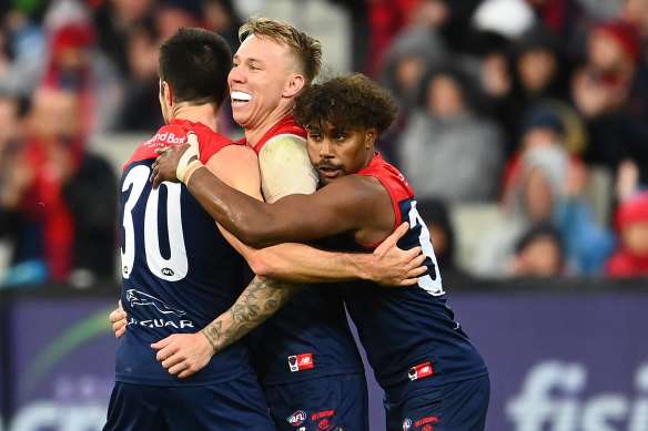 Alex Neal-Bullen, James Harmes and Kysaiah Pickett celebrate a goal.