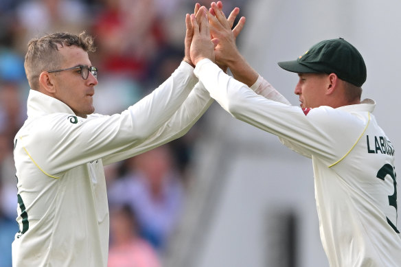 Todd Murphy celebrates his dismissal of Joe Root in England’s second innings with teammate Marnus Labuschagne.