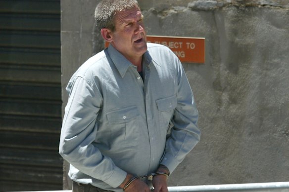 Convicted killer Bradley John Murdoch, pictured in handcuffs after facing an extradition hearing in Adelaide 2003, has died of throat cancer aged 67. 