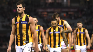 Under scrutiny: Hawthorn captain leads his team from the field after the loss to Essendon.