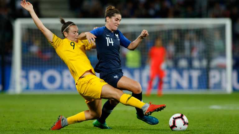 Lunge: Caitlin Foord of the Matildas and France's Charlotte Bilbault compete for the ball in midfield.