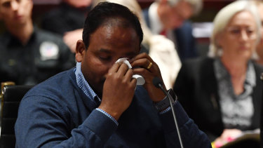 Vijay Vital wipes away tears after delivering his opening statement to the NSW upper house's inquiry into the state's building standards.