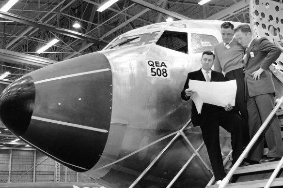 Brian Van de Water (holding plans) with VH-EBH on the production line at Seattle, 1961.  