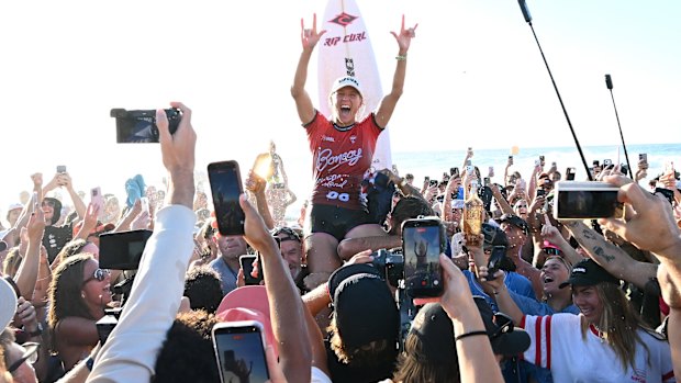 Stephanie Gilmore is mobbed on the beach after winning the Gold Coast Pro at Snapper Rocks on Monday.