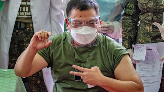 Philippine Army Commanding General Jose Faustino jnr poses with a vial of Sinovac Biotech’s CoronaVac, after being vaccinated last month.