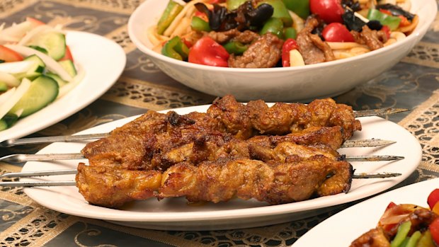 Tender lamb shoulder skewers are marinated in raw onion overnight, cooked over charcoal and seasoned with cumin.