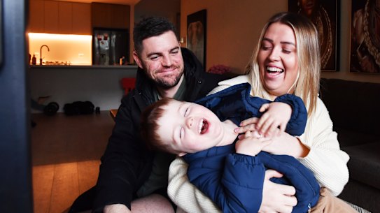 Kara Napper wth her husband, Dave, and son, Cgarlie, 2 at home in Kirrawee.