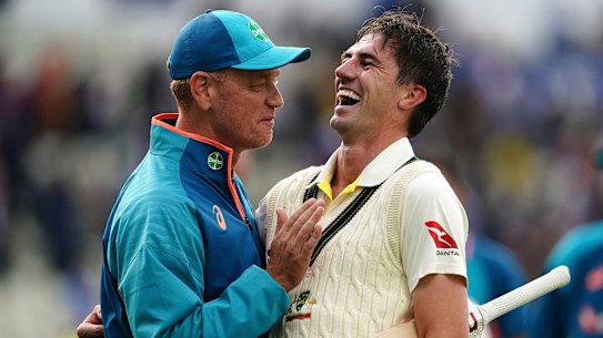 Australia captain Pat Cummins, right, celebrates with coach Andrew McDonald.