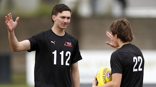 Josh Gibcus high-fives Judson Clarke at the AFL Draft Victoria training day at Trevor Barker Oval recently.