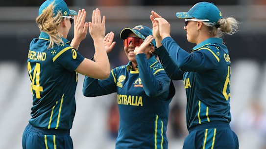 Australia's Ashleigh Gardner (R) celebrates with teammates Alana King and Annabel Sutherland (L) after taking the wicket of South Africa's Nonkululeko Mlaba during the Women's T20 World Cup match between Australia and South Africa on Saturday, June 13, 2026 in Old Trafford, Manchester, England. (Nigel French/PA via AP)