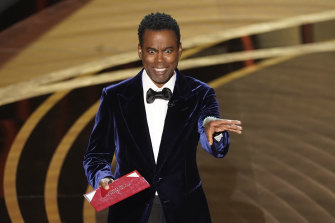 Chris Rock on stage presenting the award for best documentary feature at the 2022 Oscars.