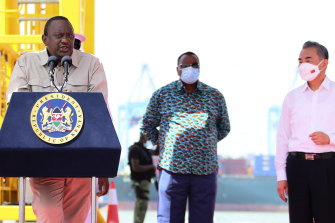 Chinese Foreign Minister Wang Yi, right, looks on as President Uhuru Kenyatta of Kenya speaks after touring the new Kipevu Oil Terminal within the port of Mombasa on January 6.