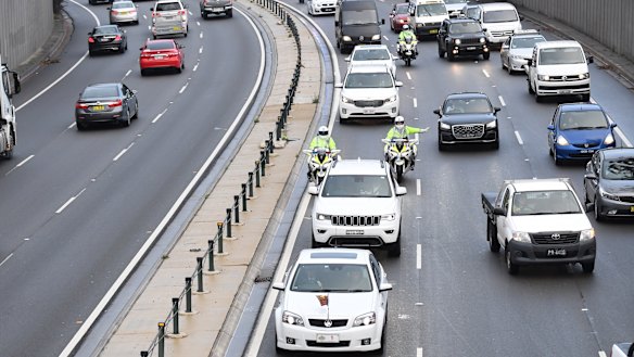 The motorcade carrying Prince Harry and Meghan Markle makes its way through peak hour traffic in Sydney.