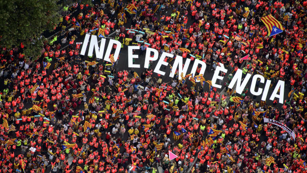 Independence supporters form the word Independence during Catalonia's National Day in Barcelona, Spain, on Tuesday. 