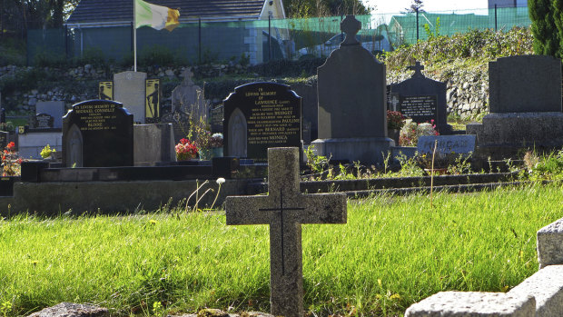 An Irish flag flies over the graves in a cemetery in Carrickcarnan, Ireland, near Northern Ireland, where the Brexit deal runs into trouble. 