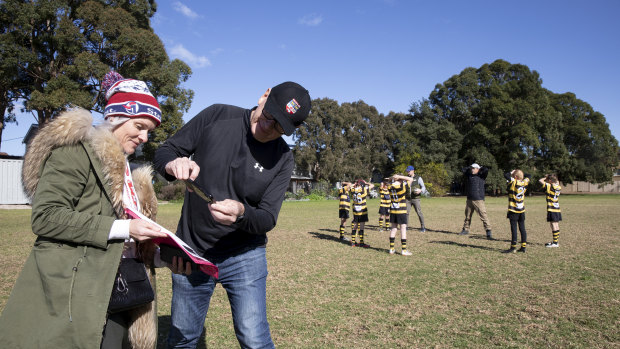 Chelsea Dunne takes down the details of a spectator at a junior rugby match at St Luke's Oval in Concord.