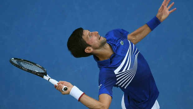 Wound up: Djokovic serves during his first-round victory.